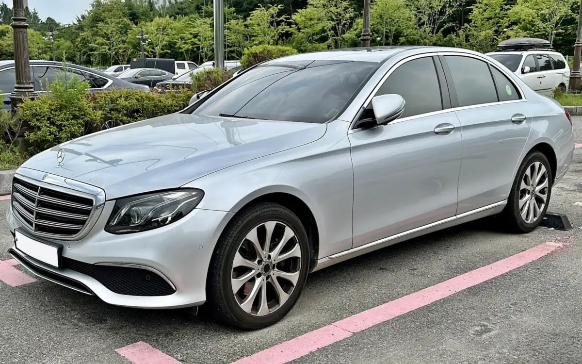 A silver Mercedes-Benz E-Class saloon, seen from the front three-quarter